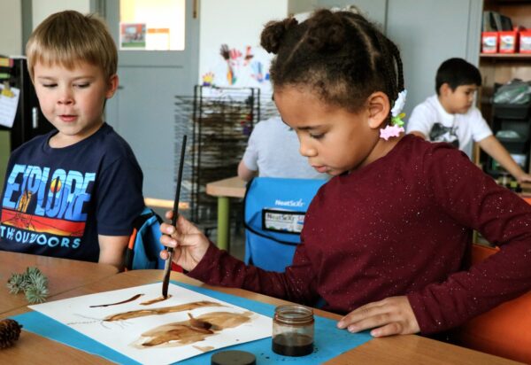 In a youth workshop, children learned about making dyes and inks from plants and painted using sitka spruce tannin ink. Photo courtesy: Sitka Center for Art and Ecology